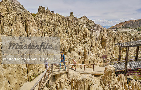 Mother and sons trekking along footpath, through rock formations, La Paz, Bolivia, South America