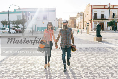Mature hipster couple strolling hand in hand, Valencia, Spain