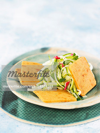 Spicy macadamia cheese crackers with courgette salad