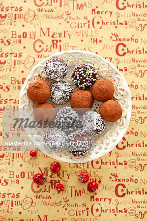 Chocolate truffles with coconut shavings, cocoa powder and sugar beads