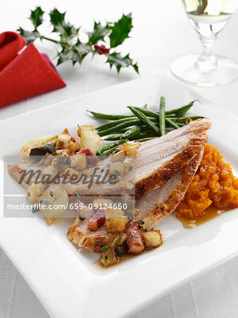 Roast turkey slices with stuffing and carrot puree