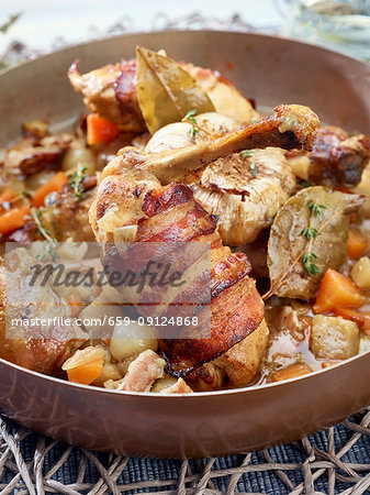 Chicken with bacon in copper pan