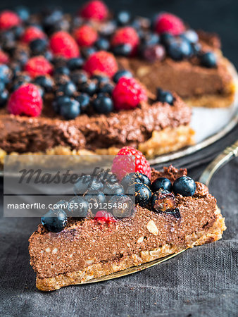 Raw vegan gluten-free chocolate tart with berries