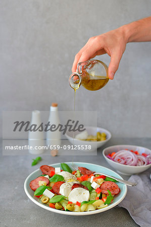 Italian-style pasta salad with olive oil basil mozzarella and olives Italian-style pasta salad with olive oil basil mozzarella and olives