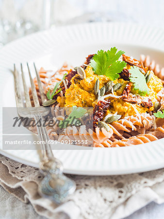 Pumpkin pesto served with whole grain spelt pasta and dry tomatoes