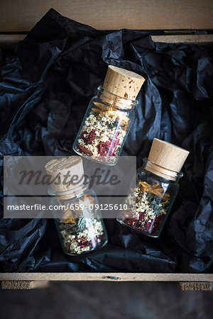 Small jars of loose leaf tea made from dried elderflowers, mint, strawberries and peach