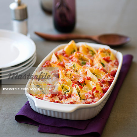 Shell pasta with a cheese and vegetable filling in a baking dish