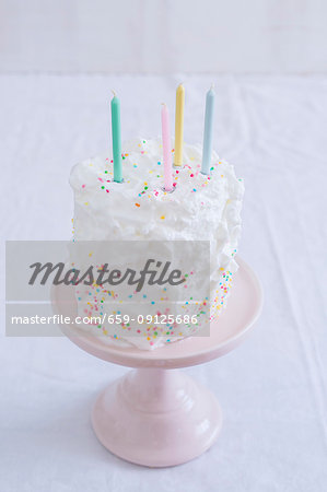 Cake with sprinkles decoration on a pink stand