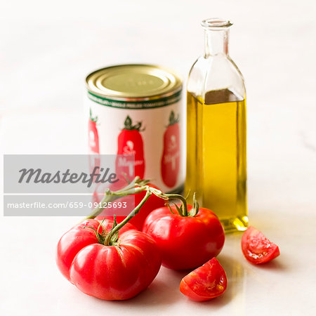 Simple tomato and olive oil still lfie on a white background