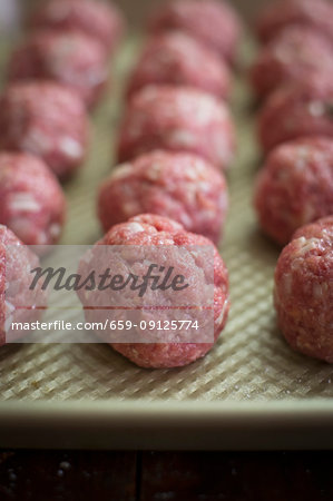 Rows of raw meatballs
