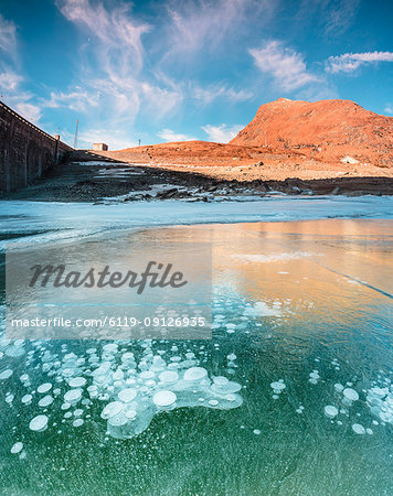 Panoramic of frozen lake Montespluga at dawn, Chiavenna Valley, Sondrio province, Valtellina, Lombardy, Italy, Europe