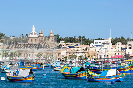 Traditional brightly painted fishing boats in the harbour at Marsaxlokk, Malta, Mediterranean, Europe