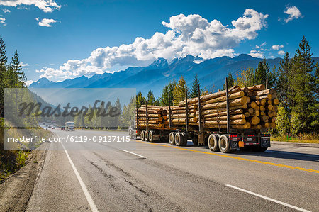 Timber laden Freightliner travelling on the Trans Canada Highway in Glacier National Park, British Columbia, Canada, North America