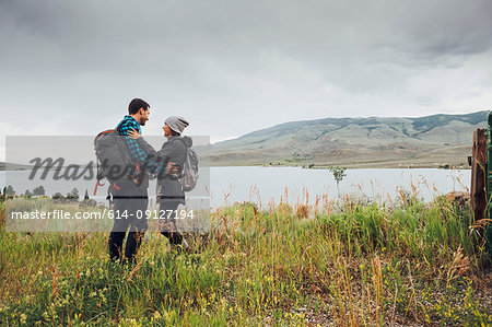 Couple standing beside Dillon Reservoir, face to face, Silverthorne, Colorado, USA