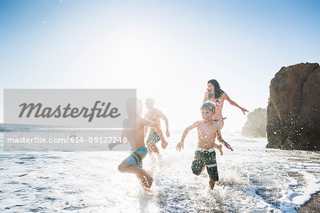 Family playing on El Matador Beach, Malibu, USA