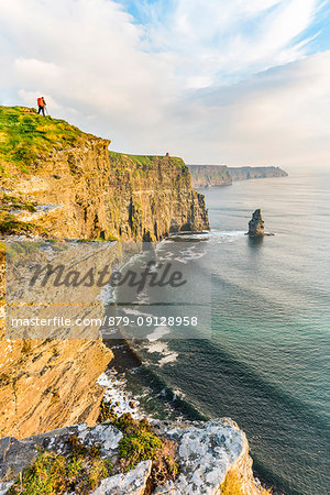 Photographer on the edge of the Cliffs of Moher, Liscannor, Co. Clare, Munster province, Ireland.