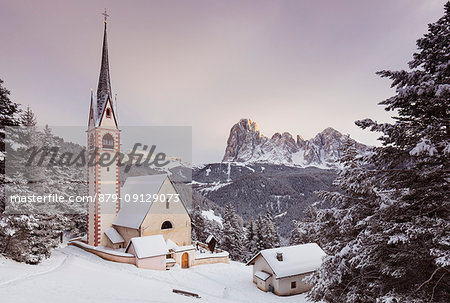 a beautiful sunset by the Church of San Giacomo in Val Gardena with Langkofel and Plattkofel in the background, Bolzano province, South Tyrol, Trentino Alto Adige, Italy