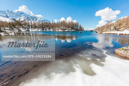 Lago Acque Sparse partially frozen, Val Grosina, Valtellina, province of Sondrio, Lombardy, Italy Lago Acque Sparse partially frozen, Val Grosina, Valtellina, province of Sondrio, Lombardy, Italy