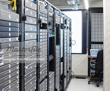 Servers in an aisle of racks in a computer server farm.