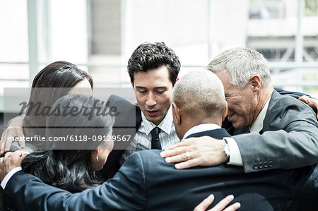 Mixed race group of business people in an informal team building meeting.