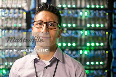 Caucasian man technician in a large computer server farm.