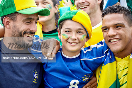 Brazilian football fans bonding at match, portrait