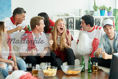 English soccer fans watching match together at home