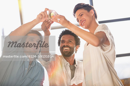 Smiling, innovative entrepreneurs examining prototype