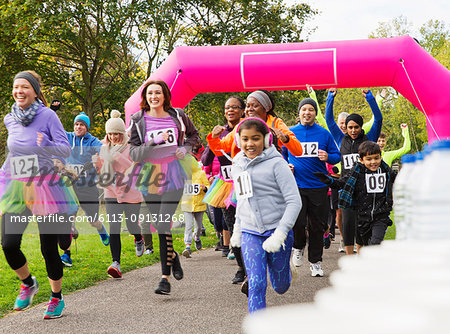 Enthusiastic runners running at charity run in park