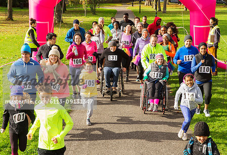 Crowd running at charity run in sunny park