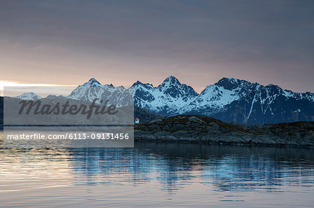 Tranquil view of snowy mountains beyond fjord, Maervoll, Lofoten, Norway