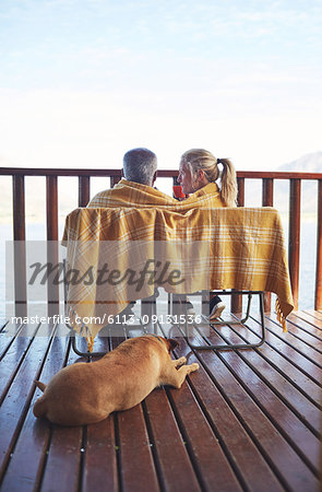 Cozy couple and dog on balcony