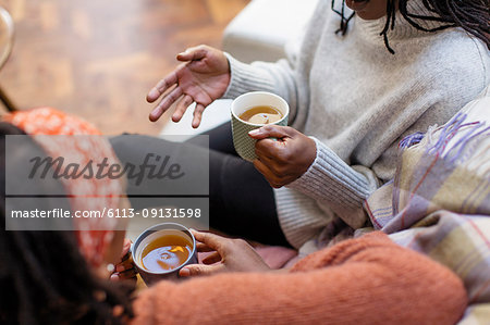Women friends talking and drinking tea