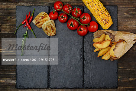 Delicious sliced steak with spices on board and grey table.