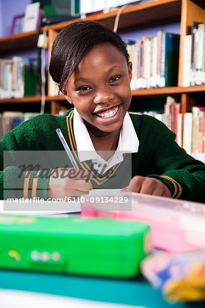 A young girl in school uniform sitting at a desk, Meyerton Primary School, Meyerton, Gauteng