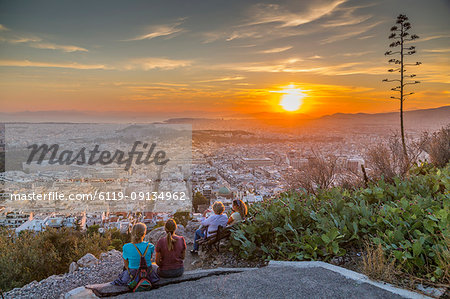 People watching sunset over Athens from Likavitos Hill, Athens, Greece, Europe