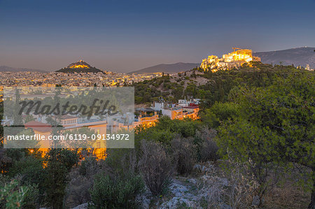 View of The Acropolis and Likavitos Hill at dusk from Filopappou Hill, Athens, Greece, Europe