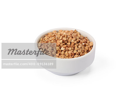 Buckwheat groats in whitebowl isolated on white background.