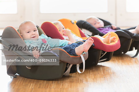 Infants in toddler group lying in baby shells