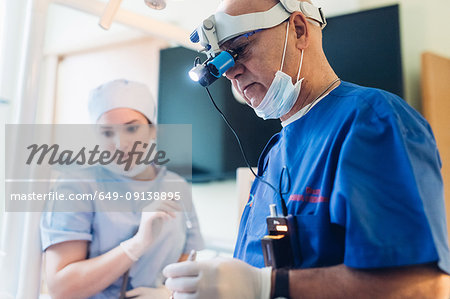 Dentist wearing dental binocular loupes