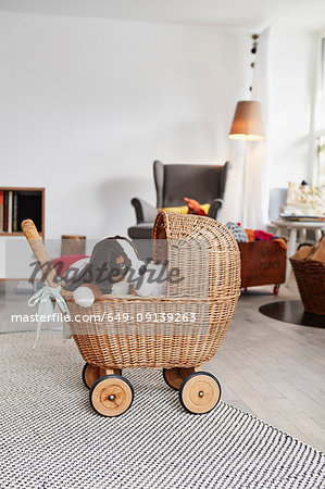 Toy dog in wicker dolls pram