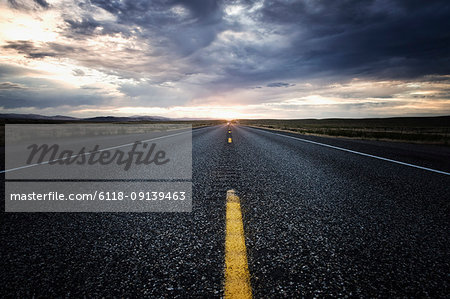 View down the centre line of a state highway at sunset in eastern Washington, USA.