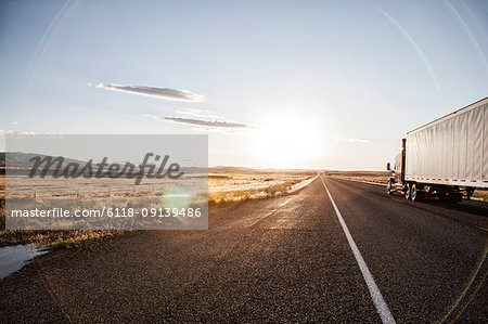 Side view of a trailer and truck on the road at sunset  in eastern Washington,  USA