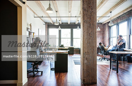 Asian woman working at her desk in a creative office.