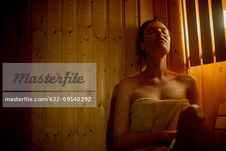 Woman relaxing in sauna