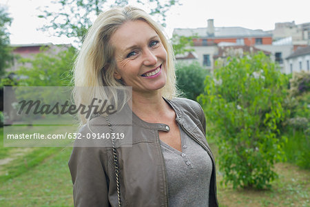 Mature woman smiling outdoors, portrait