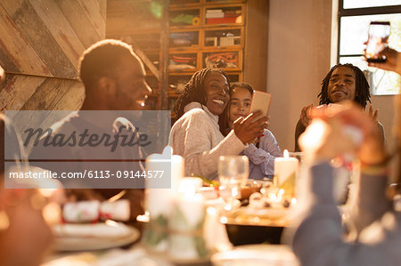 Mother and daughter taking selfie at Christmas dinner table