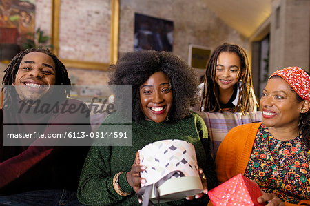 Portrait smiling, happy family opening Christmas gifts