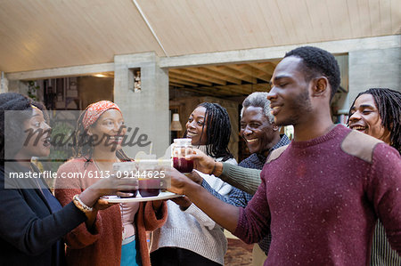 Multi-generation family enjoying sangria on patio