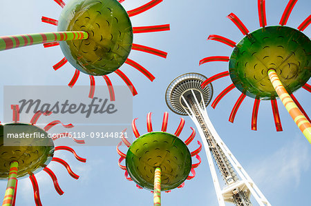 Low angle view of the Space Needle in Seattle, Washington, USA, with colourful flower sculptures.